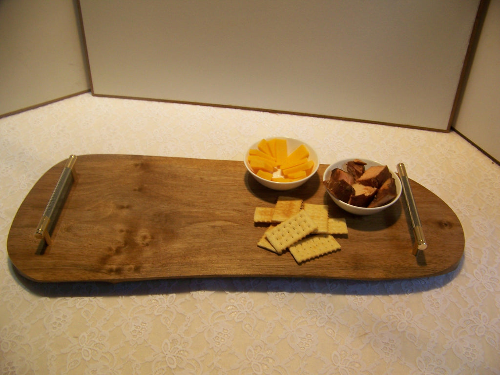 Live Edge Walnut Charcuterie Board with Brass/gray knurled handles.