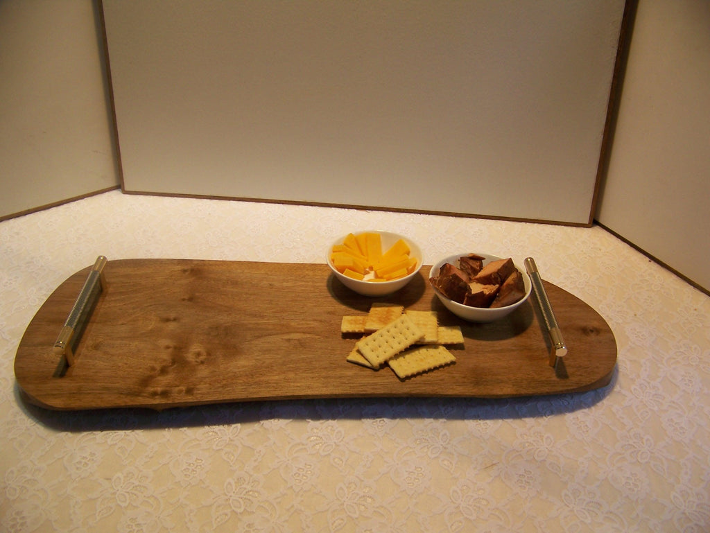 Live Edge Walnut Charcuterie Board with Brass/gray knurled handles.