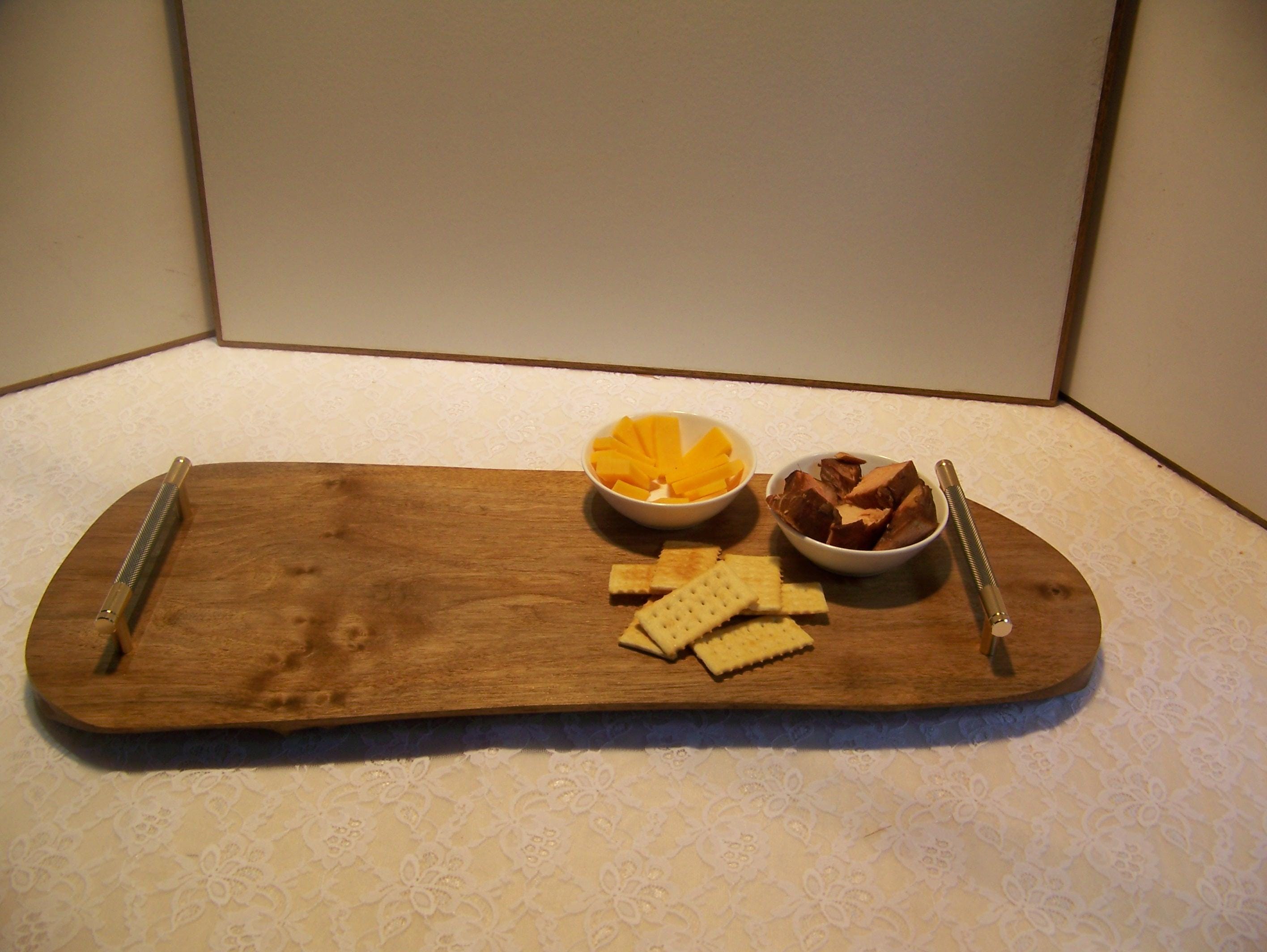 Live Edge Walnut Charcuterie Board with Brass/gray knurled handles.
